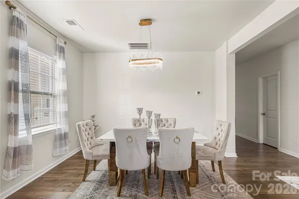 a view of a dining room with furniture wooden floor and carpet