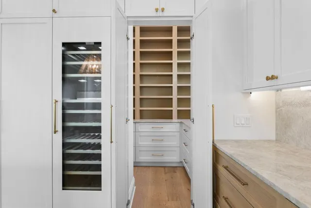 a view of a walk in closet and wooden floor