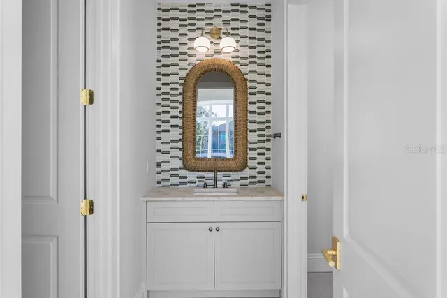 a bathroom with a granite countertop toilet sink and mirror