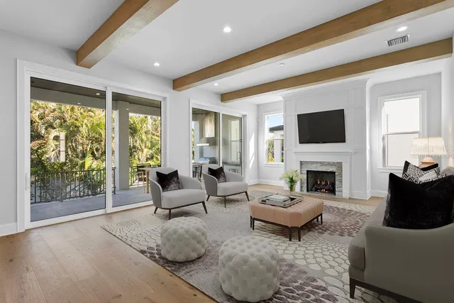 a living room with furniture a fireplace and a flat screen tv