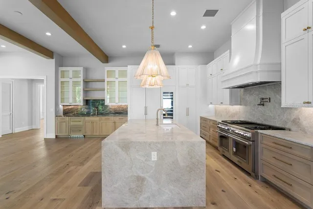 a kitchen with stainless steel appliances granite countertop a stove a sink and a refrigerator