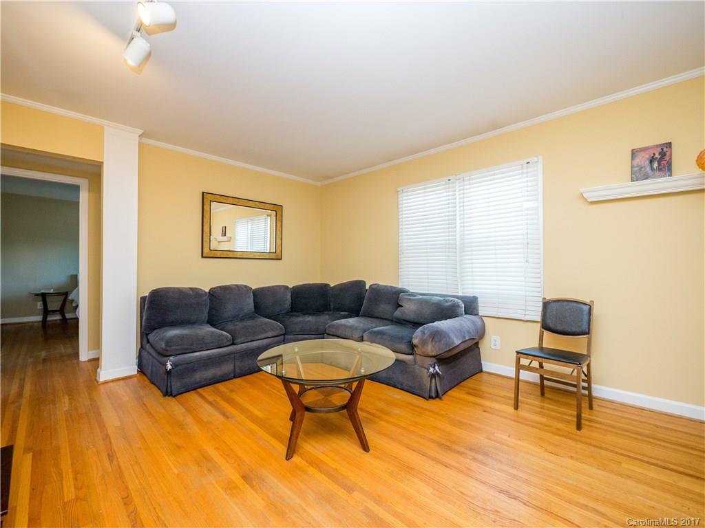 910 McAlway Road, Unit E Charlotte, NC 28211 - Photo 2 of 13 a living room with furniture and a wooden floor