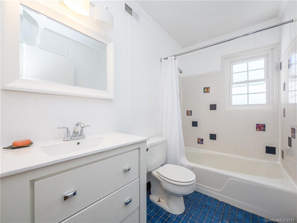 910 McAlway Road, Unit E Charlotte, NC 28211 - Photo 11 of 13 a bathroom with a sink a toilet and a bathtub