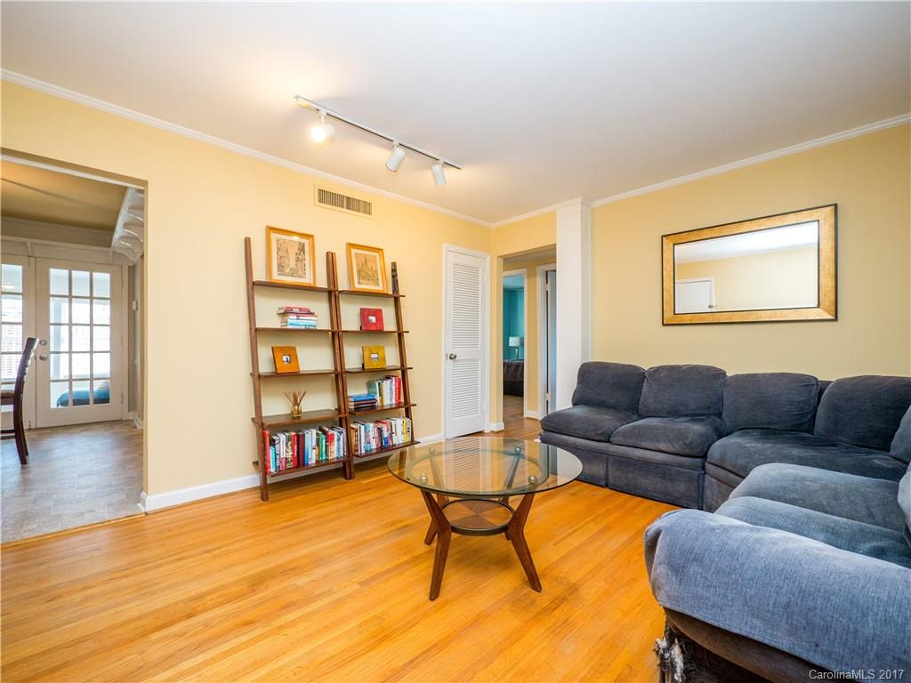 910 McAlway Road, Unit E Charlotte, NC 28211 - Photo 3 of 13 a living room with furniture and a wooden floor