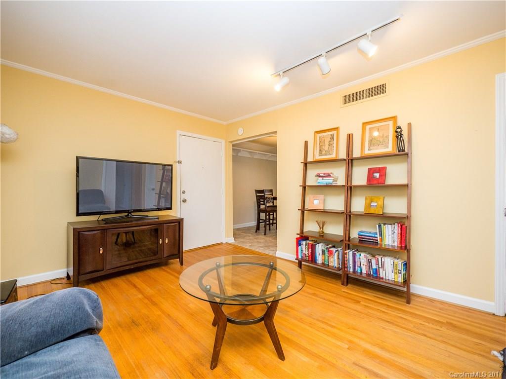 910 McAlway Road, Unit E Charlotte, NC 28211 - Photo 4 of 13 a living room with fish tank and a bookshelf