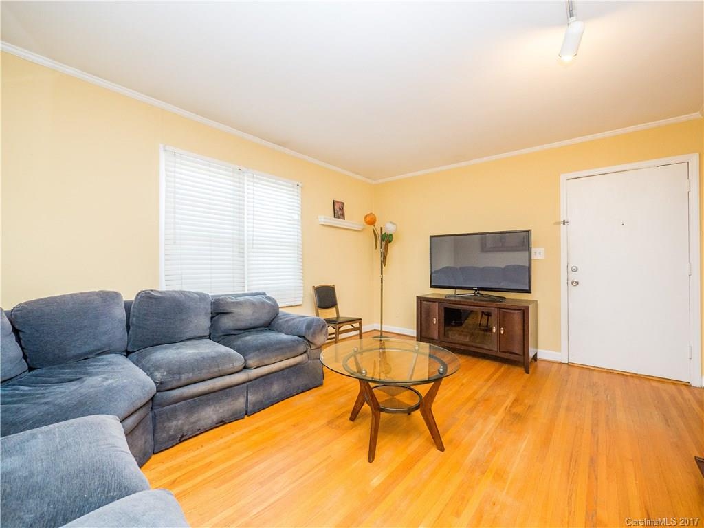 910 McAlway Road, Unit E Charlotte, NC 28211 - Photo 5 of 13 a living room with furniture a flat screen tv and a window