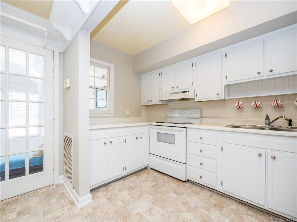 910 McAlway Road, Unit E Charlotte, NC 28211 - Photo 7 of 13 a kitchen with granite countertop white cabinets and white stainless steel appliances