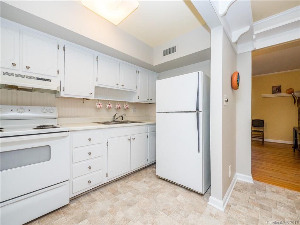910 McAlway Road, Unit E Charlotte, NC 28211 - Photo 9 of 13 a kitchen with cabinets appliances and a refrigerator