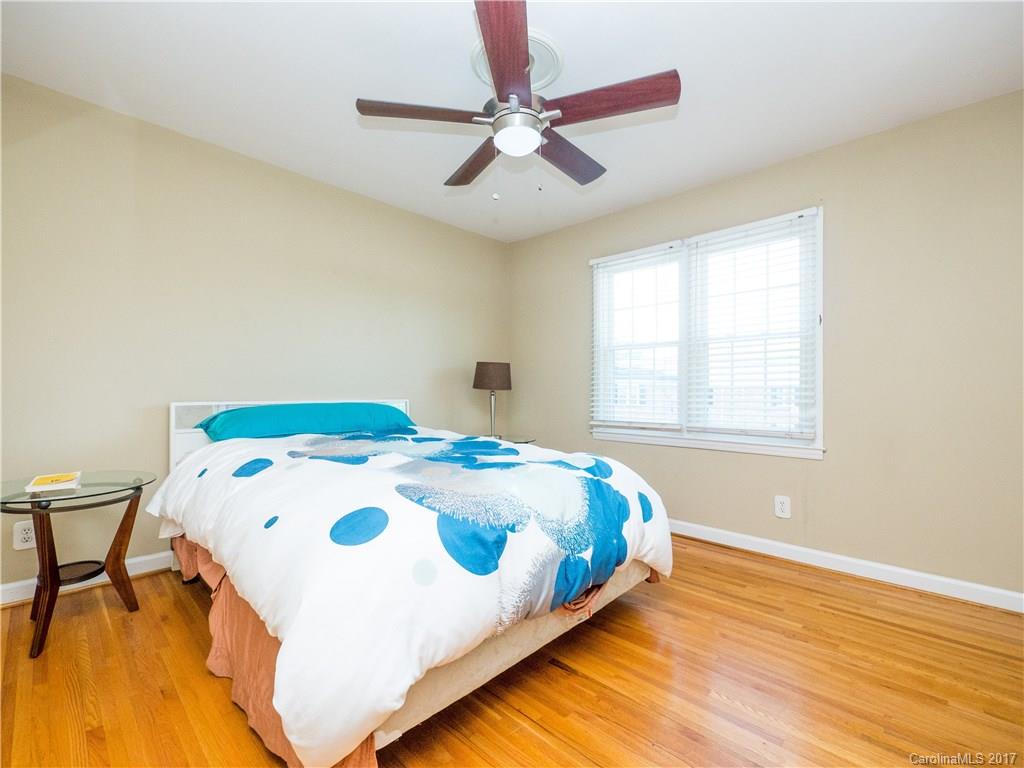 910 McAlway Road, Unit E Charlotte, NC 28211 - Photo 10 of 13 a bedroom with a bed and a table in it