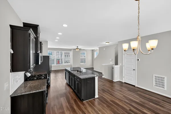 a kitchen with stainless steel appliances granite countertop a stove and cabinets