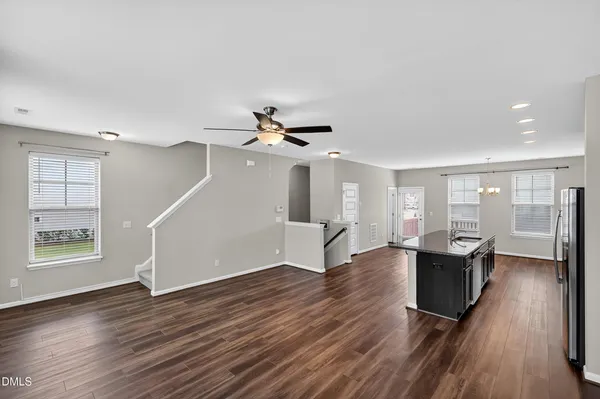 a kitchen with stainless steel appliances granite countertop a sink refrigerator and microwave