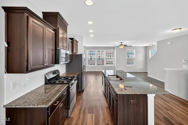 a view of a livingroom with hardwood floor and a ceiling fan