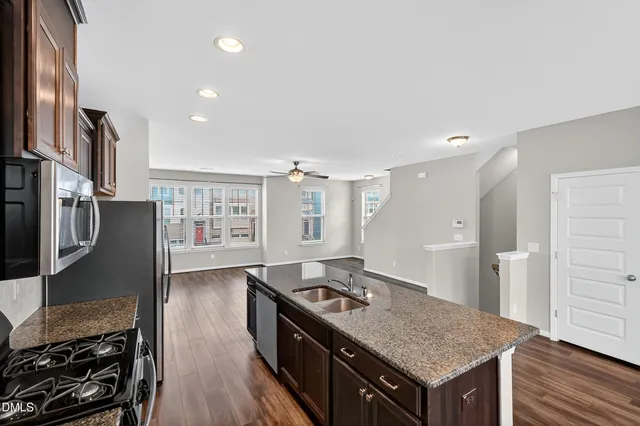 a kitchen with a refrigerator a stove a sink and a oven