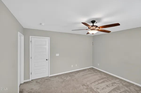 a view of a livingroom with a ceiling fan and window
