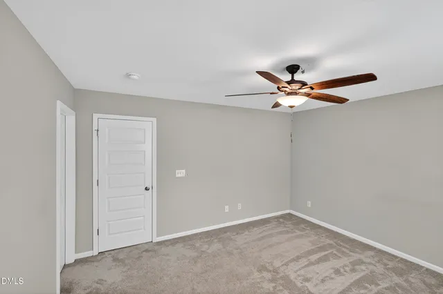 a view of a livingroom with a ceiling fan and window