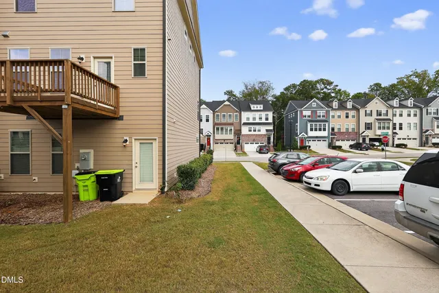 a view of a house with backyard and sitting area