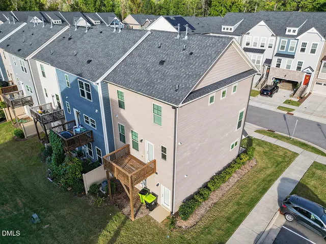 a view of a cars park in front of a house