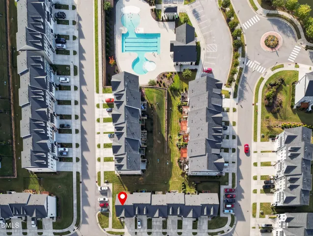 an aerial view of a house with a swimming pool outdoor seating and outdoor kitchen