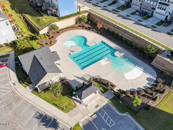 an aerial view of a house with a swimming pool