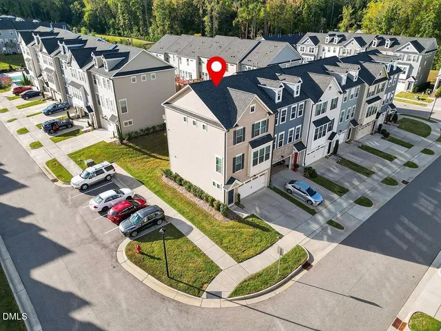 a aerial view of a house with swimming pool and big trees