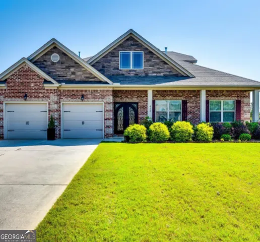 a view of a house with garden and yard