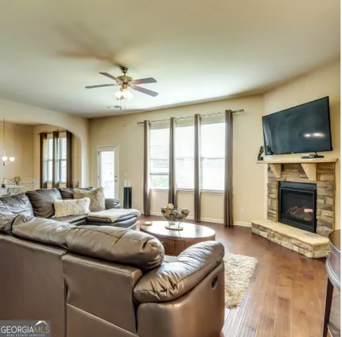 a living room with fireplace furniture and a flat screen tv