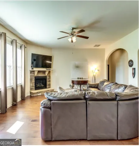 a living room with furniture a fireplace and a flat screen tv