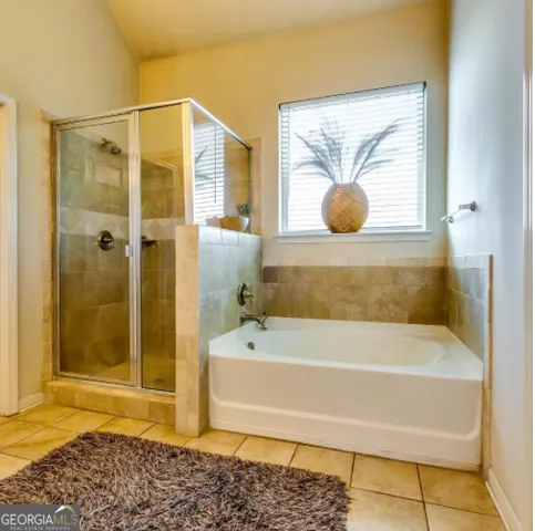 a bathroom with a tub and shower