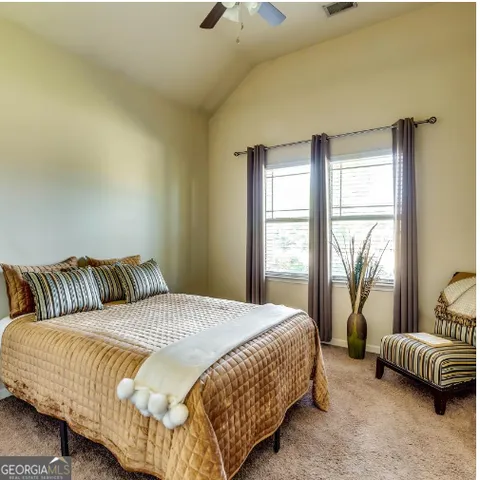 a bedroom with a bed and a couch