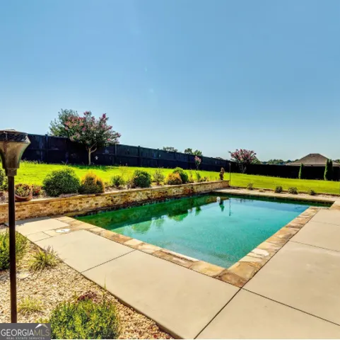a view of a swimming pool and a yard