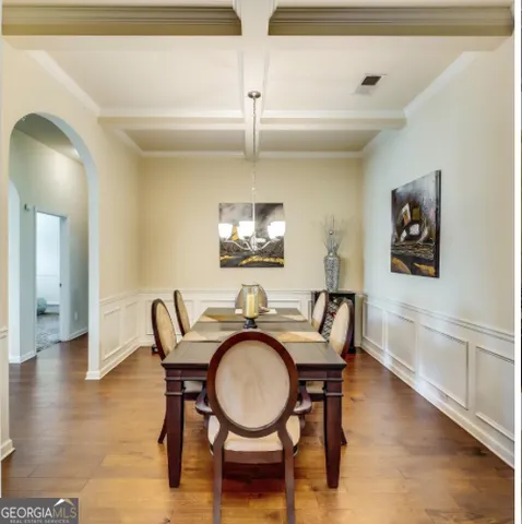 a dining room with furniture and wooden floor
