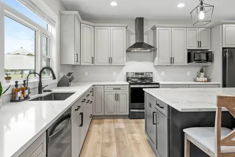 an open kitchen with a table and chairs in it