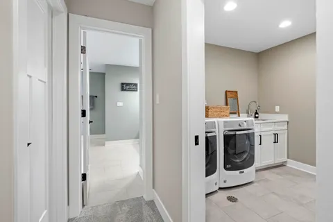 a bathroom with double vanity sinks and a mirror