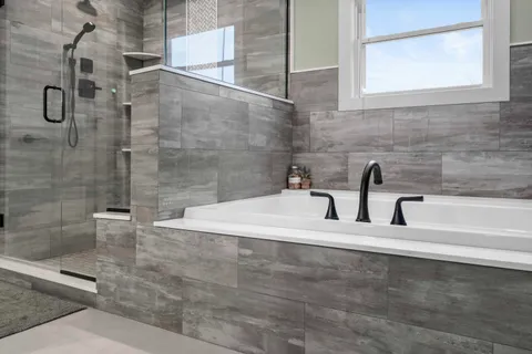 a spacious bathroom with a shower sink and mirror