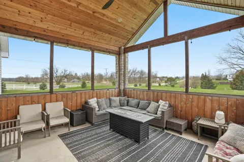 a view of a house with backyard sitting area and garden