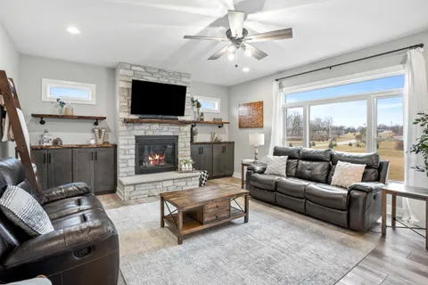a living room with furniture and wooden floor