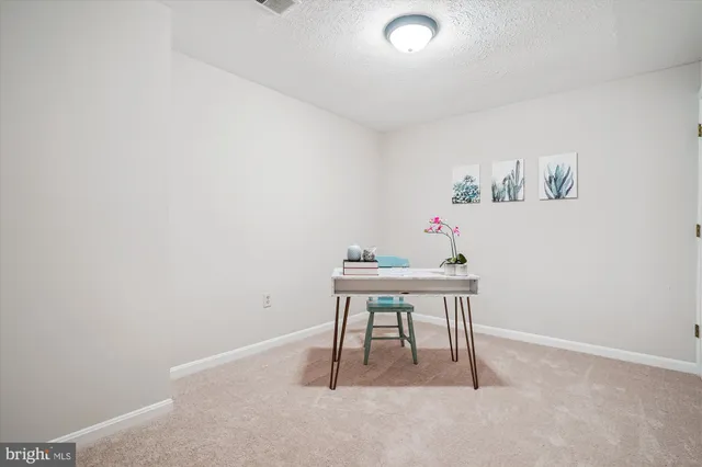 a picture of a bench in front of a wall