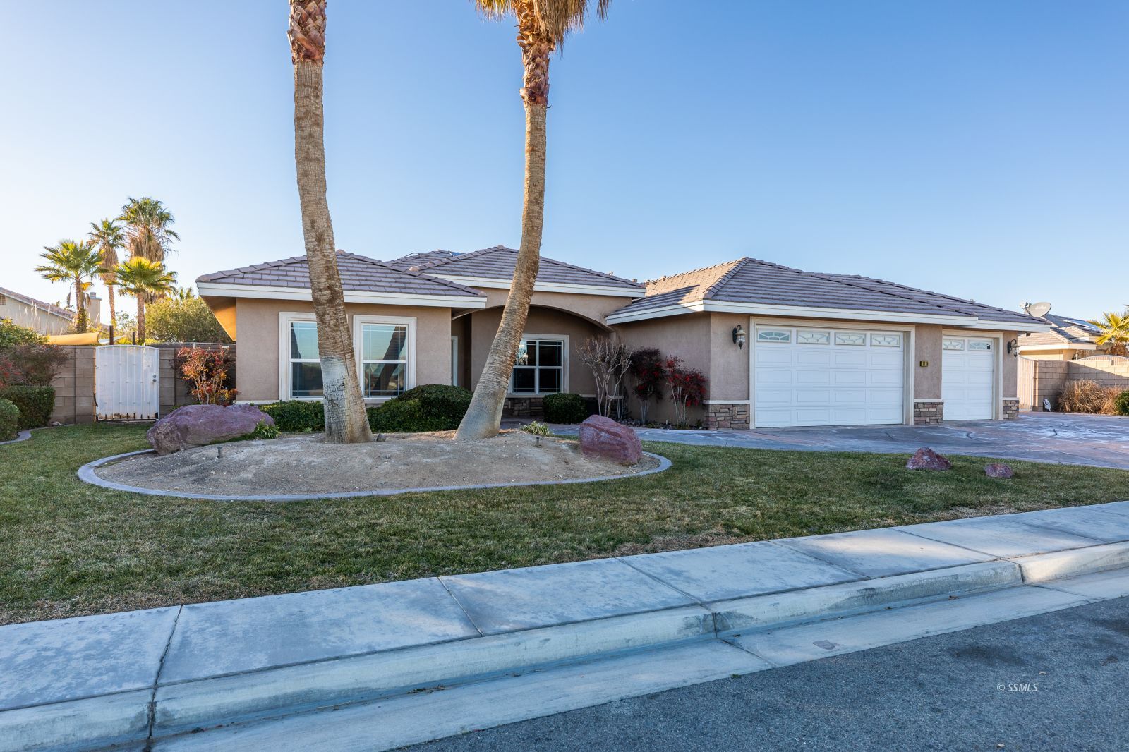 1219 Carolyn Street Ridgecrest, CA 93555 - Photo 2 of 47 a front view of a house with a yard and garage