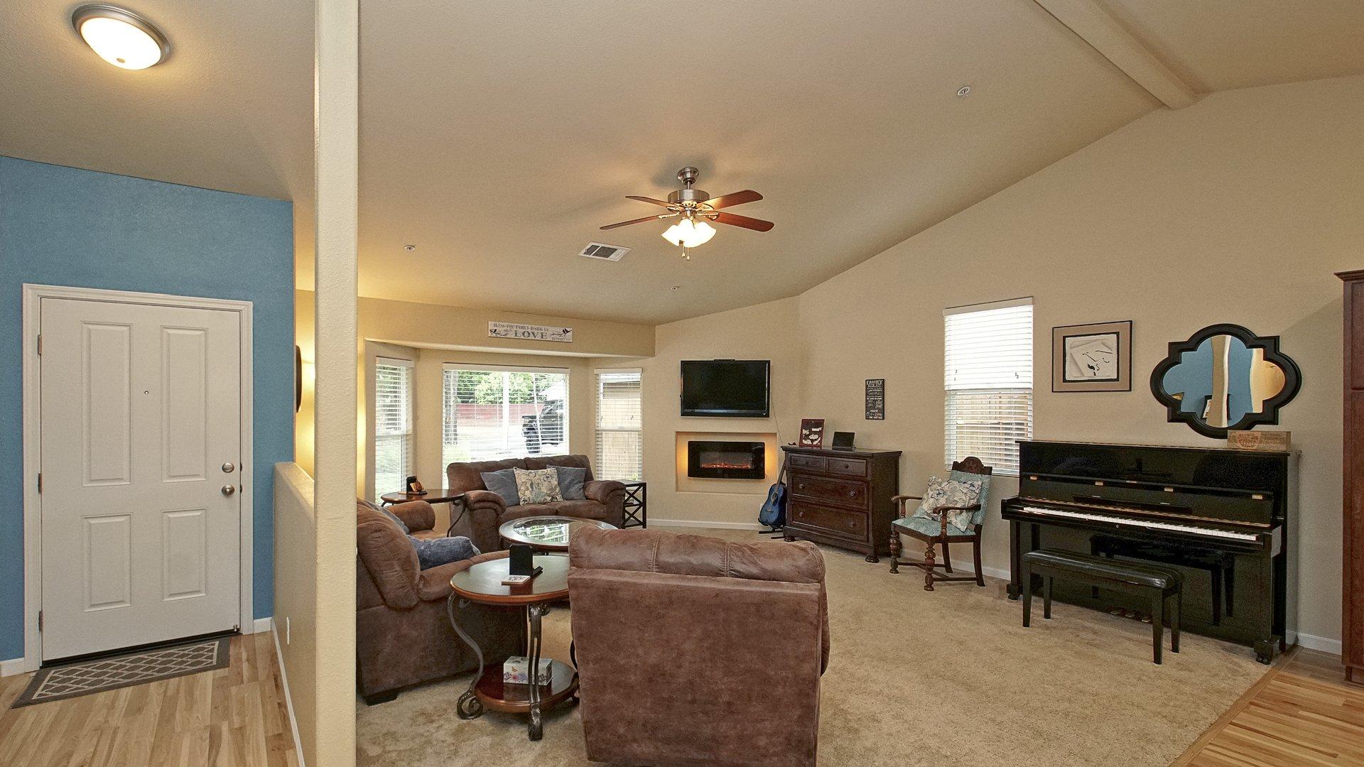7139 Pit Road Redding, CA 96001 - Photo 9 of 28 a living room with furniture a fireplace and a flat screen tv