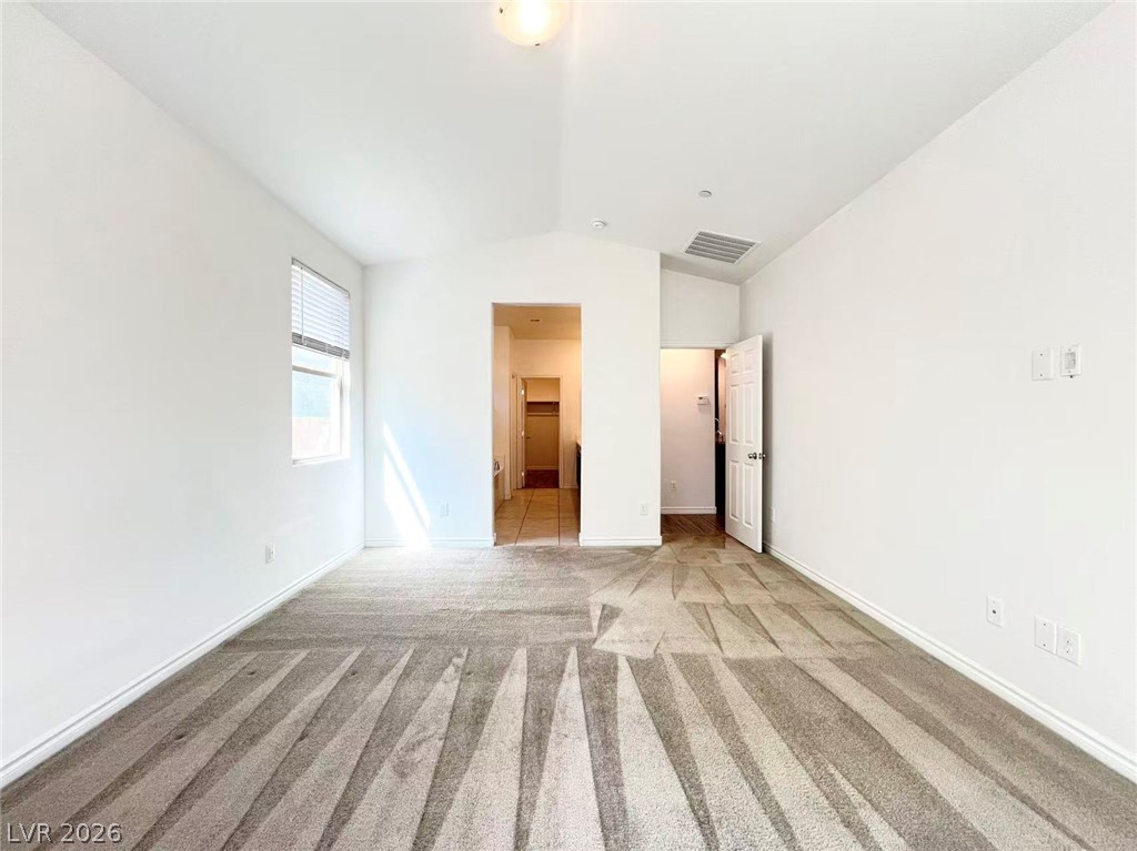 925 Bayberry Ridge Street Henderson, NV 89052 - Photo 6 of 27 A well-lit room with fresh carpet flooring and a wide window, offering a neutral canvas for your personal style.