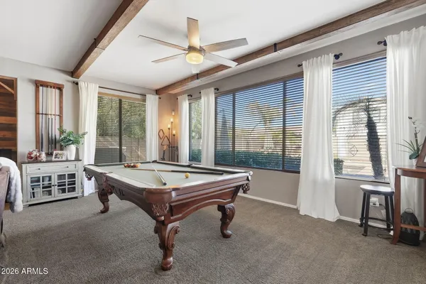 a living room with furniture pool table and a table