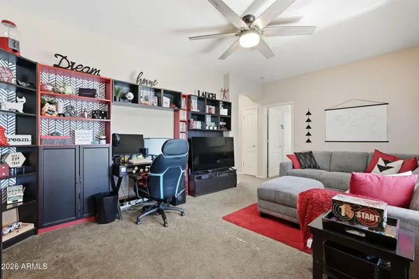 a bedroom with a bed and a flat tv screen on dresser