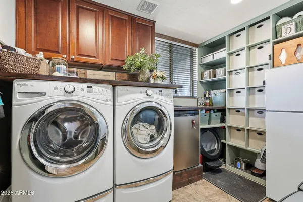 a view of a chair and table in the back yard of the house