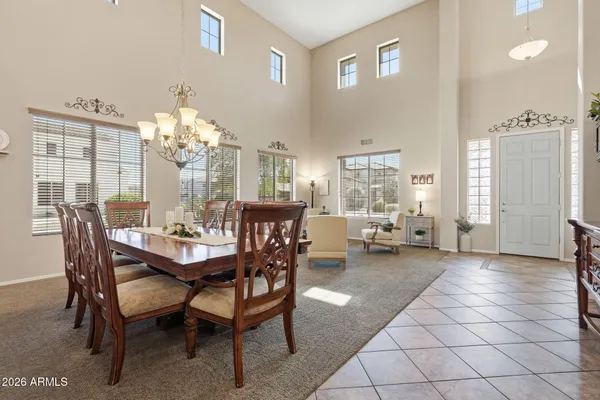 a view of a dining room with furniture and chandelier