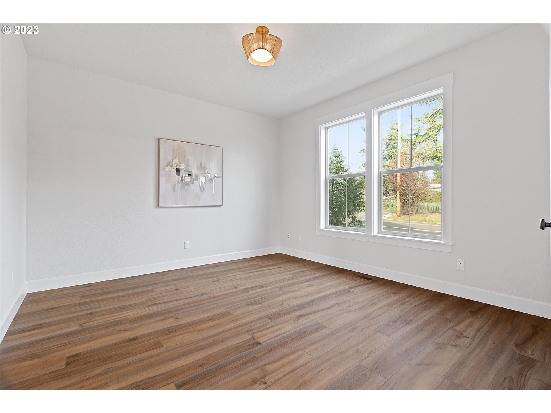 19699 Leland Road Oregon City, OR 97045 - Photo 12 of 38 a view of an empty room with wooden floor and a window