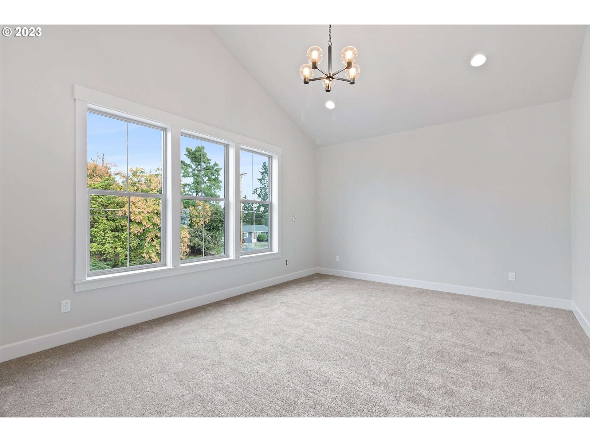 19699 Leland Road Oregon City, OR 97045 - Photo 21 of 38 an empty room with windows and chandelier fan