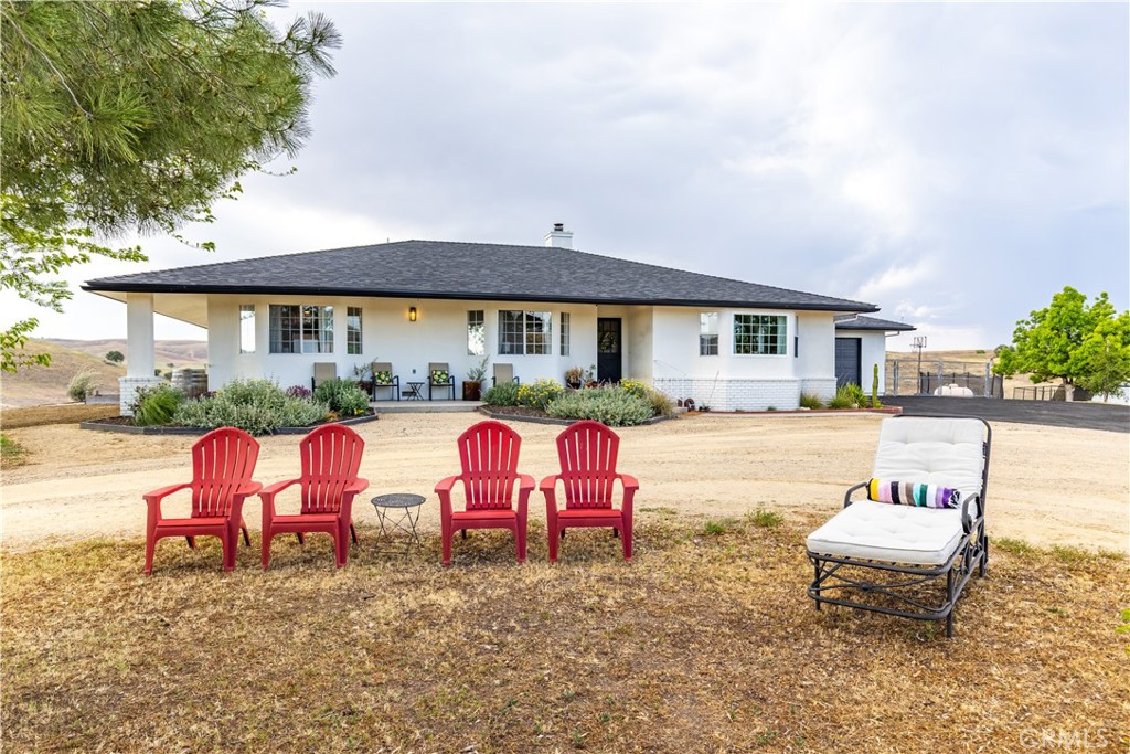 a view of a house with backyard sitting area and garden