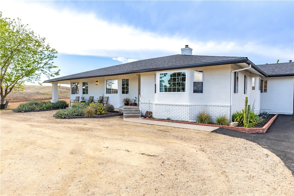 3150 Bluegrass Place Creston, CA 93432 - Photo 13 of 58 a front view of a house with garden