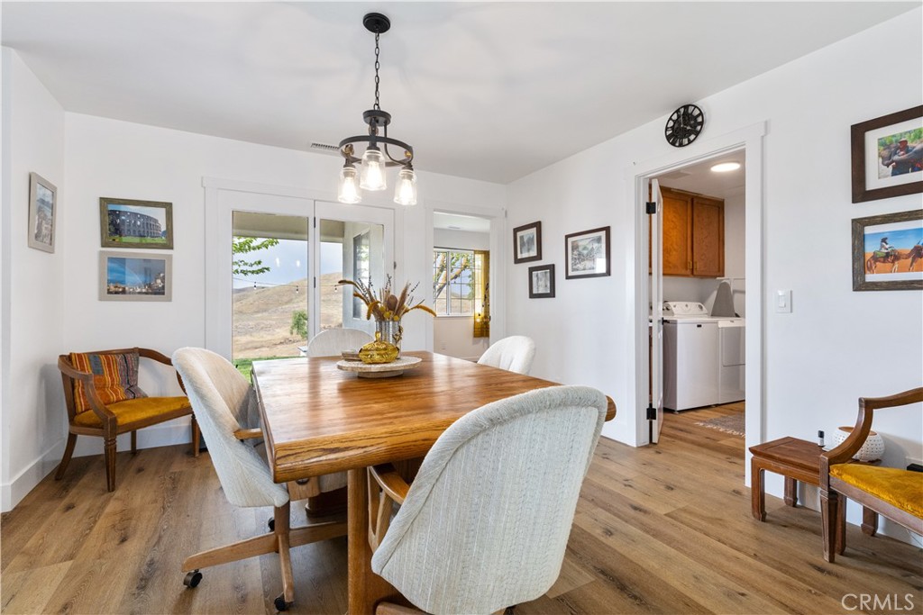 3150 Bluegrass Place Creston, CA 93432 - Photo 24 of 58 a view of a dining room with furniture and wooden floor