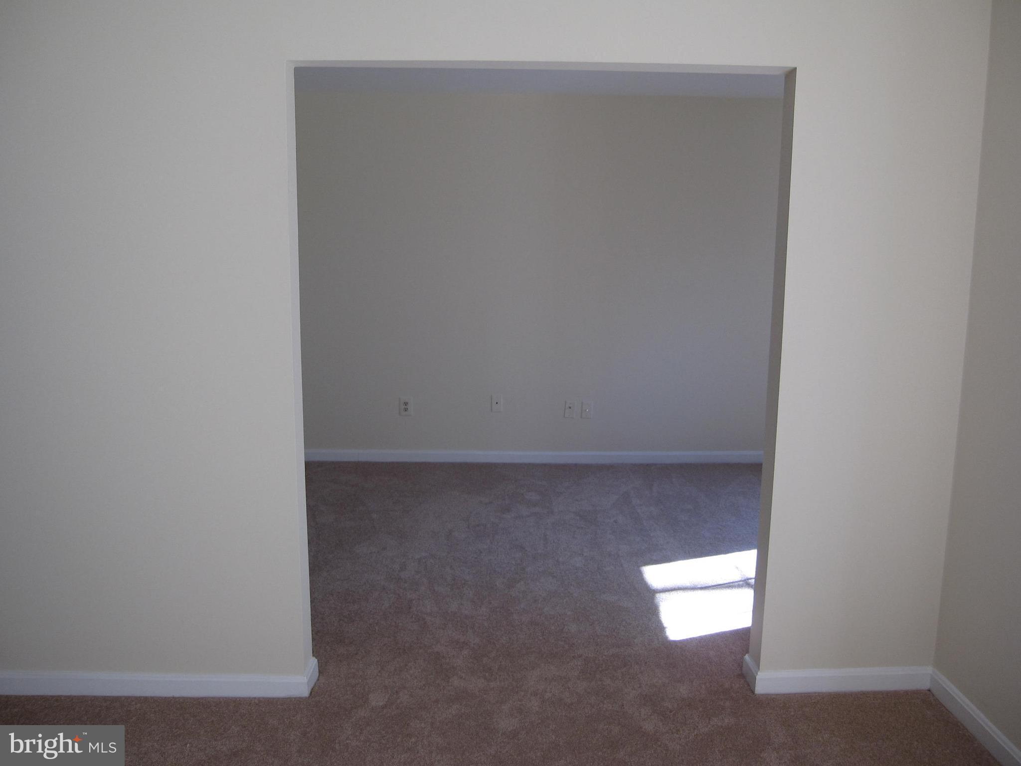 21 Rain Flower Path, Unit 103 Sparks, MD 21152 - Photo 16 of 27 Entry from Living Room to Den